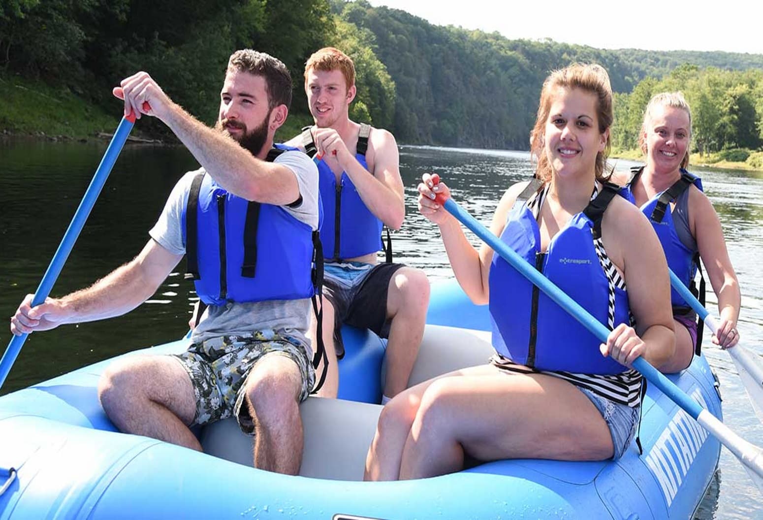 four adults inside an inflatable raft four adults inside an inflatable raft